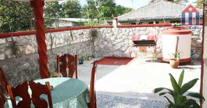 Behind the house you have this large terrace with covered part with dining area
