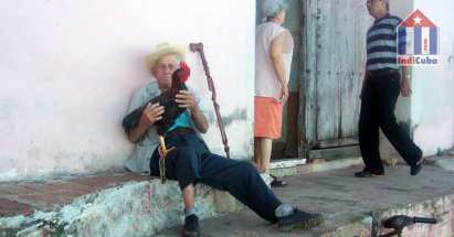 Sight seeing in the old town of Cuba Trinidad - old men with cock